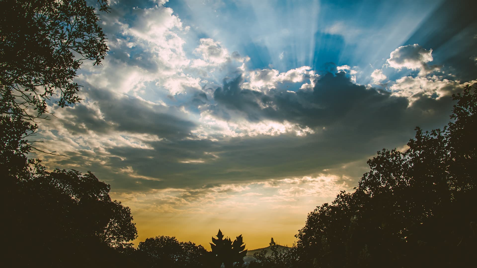 Corriente de nubes en tinta oscura con movimiento azul sutil y luz suave en los bordes.